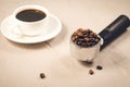 Holder filled with beans and coffee cup/holder filled with beans Royalty Free Stock Photo