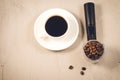 Holder filled with beans and coffee cup/holder filled with beans and coffee cup, top view Royalty Free Stock Photo