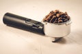 holder filled with coffee beans/holder filled with coffee beans on a concrete background Royalty Free Stock Photo