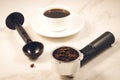 holder filled with ground coffee, spoon and cup/ holder filled with ground coffee, spoon and cup on a marble background Royalty Free Stock Photo