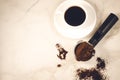 holder filled with ground coffee and a white cup/holder filled with ground coffee and a white cup on a marble background. Top view Royalty Free Stock Photo