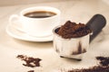 Holder filled with ground coffee and a white cup/holder filled with ground coffee and a white cup. Selective focus Royalty Free Stock Photo