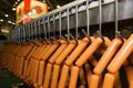 Holder with sausage on conveying machine beltline Royalty Free Stock Photo