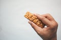 holding a Almond , Raisin and oat protein bar Royalty Free Stock Photo