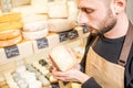 Holding a blue cheese at the store Royalty Free Stock Photo