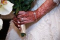 Holding bouquet close up of brides ring Royalty Free Stock Photo