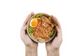 Holding bowl Hot and Spicy noodles and ingredients on isolated white background, Thai noodles with boil eggs in bowl, copy space a Royalty Free Stock Photo