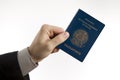 Holding a Brazilian passport.