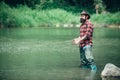 Holding brown trout. Fly angler man on the river. Bearded retro fisherman and trophy trout. Catch fish. Royalty Free Stock Photo