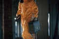 Holding case and flashlight. Man dressed in chemical protection suit in the ruins of the post apocalyptic building Royalty Free Stock Photo