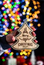 Holding Christmas decoration isolated on background with blurred lights. December season, Christmas composition Royalty Free Stock Photo