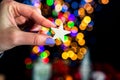 Holding Christmas glittery star decoration isolated on backgroun