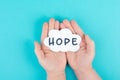 Holding a cloud with the word hope in the palm of the hands, trust and believe concept, having faith in the future, hopeful Royalty Free Stock Photo