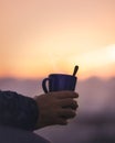 Holding a coffe mug in a warm auttum sunset Royalty Free Stock Photo