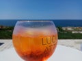 Holding the cold fresh tropical fruit juice in the glass in front of the seaside Royalty Free Stock Photo