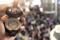 Holding compass on blurred background. Using wallpaper or background