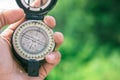 Holding compass on blurred background. Using wallpaper or background travel or navigator image