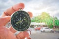 holding compass on tree mountain and sea blurry background. Using wallpaper or background travel or navigator image.