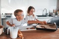 Holding cookie. Little boy and girl preparing Christmas sweets on the kitchen Royalty Free Stock Photo