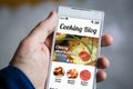 holding cooking blog smartphone