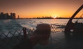 Holding a cop of coffee on the ferry from Manhattan to Staten Island during an amazing sunrise