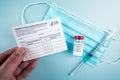 Holding a Covid-10 vaccination record card with vaccine vial, syringe Royalty Free Stock Photo