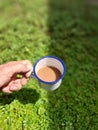 Holding a Cup of Coffee Milk in Bright and Dark Area