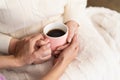 Holding cup of tea on knees Royalty Free Stock Photo