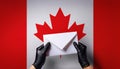 Holding an envelope in front of the Canadian flag representing communication and connection Royalty Free Stock Photo