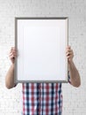 Holding frame mockup. Photo Mockup. The man hold frame. Royalty Free Stock Photo