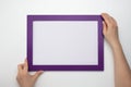 Holding frame mockup. Photo Mockup. Woman hands hold purple frame. For frames and posters design. Frame size A4. blank photo frame Royalty Free Stock Photo