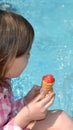 Holding fresh waffle cone with raspberry ice cream