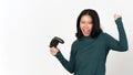Holding Game Controller and Playing, Yes and Happy face gesture Of Beautiful Asian Woman Isolated On White Background Royalty Free Stock Photo