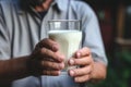 Holding a glass of milk, man advocates daily intake for calcium