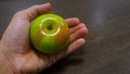 Holding a green apple Royalty Free Stock Photo