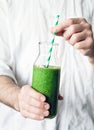 Holding green smoothie. Healthy detox smoothie in hands Royalty Free Stock Photo