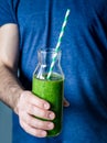 Holding green smoothie. Healthy detox smoothie in hands Royalty Free Stock Photo