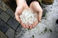 Holding hail stones in hand after hailstorm