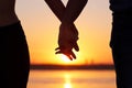 Holding hands at the beach. Silhouette couple at sunrise holding their hands in romantic scene Royalty Free Stock Photo