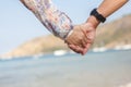 Holding hands couple on beach.