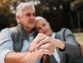 Holding hands, couple and a cane in nature for love, bonding and support. Peace, closeup and a senior man and woman in a Royalty Free Stock Photo
