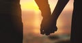 Holding hands, couple and sunset sky at beach with love on vacation, holiday or adventure. Man and woman silhouette Royalty Free Stock Photo