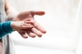 Holding Hands. hand the sleeping baby in the hand of father close-up. hands on white background Royalty Free Stock Photo