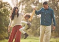 Holding hands, park and parents playing with girl in nature for fun, bonding and relax together. Happy family, childhood Royalty Free Stock Photo