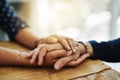 Holding hands, support and comfort of two people talking through a difficult problem. Closeup of friends showing care