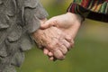 Holding hands together - old and young. Love.