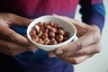 holding a hazelnuts bowl closeup Royalty Free Stock Photo