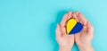 Holding a heart with the flag of Ukraine, national idendity, war crisis between Ukraine and Russia, political issue Royalty Free Stock Photo