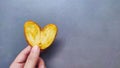 holding a heart-shaped pie biscuit on a gray background Royalty Free Stock Photo