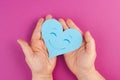 Holding a heart with a smiling face, colorful background with copy space, valintines day